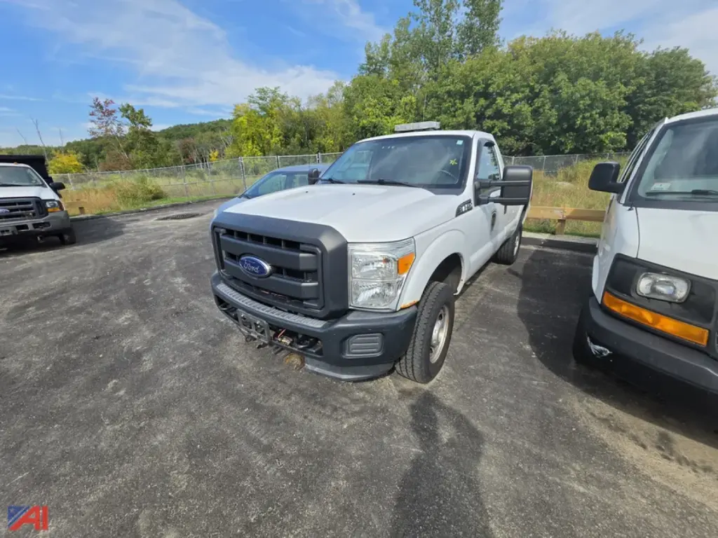 Ford F-250 Super Duty pickup with single rear wheel, front view, gray color, utility bumper, large side mirrors, in a parking lot.