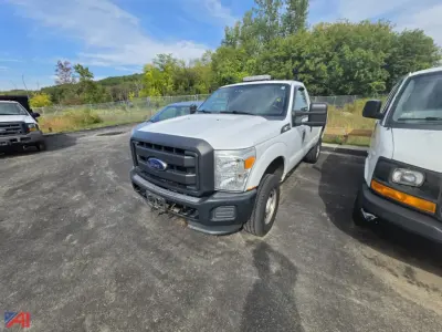 Ford F-250 Super Duty pickup with single rear wheel, front view, gray color, utility bumper, large side mirrors, in a parking lot.