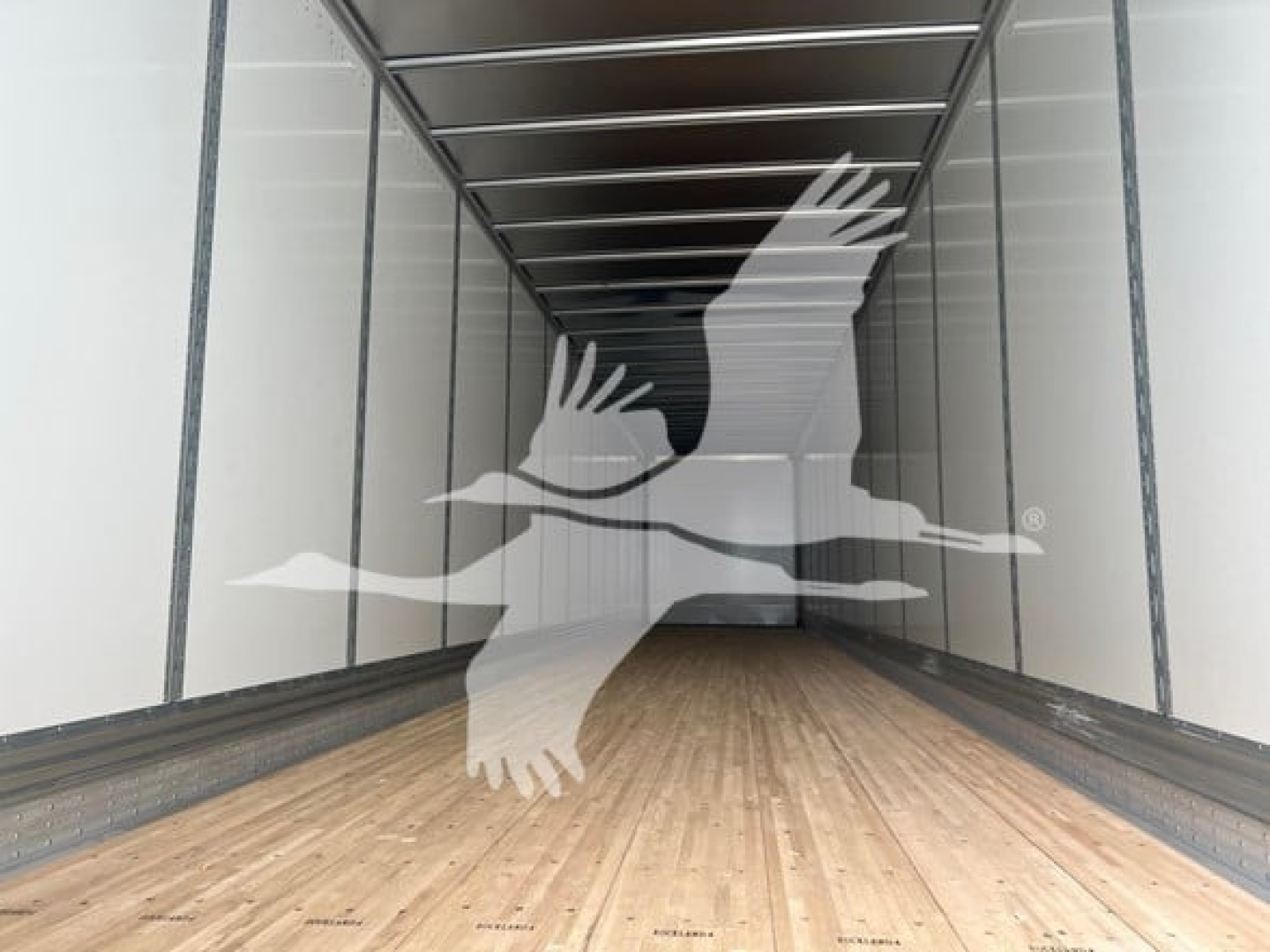 2027 Vanguard VXP Plate Van trailer interior showing wooden floor and metal side rails with a watermark of flying birds logo overlay.