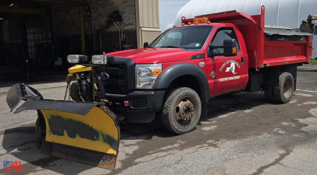 Ford F-Series 2011 F550 dump truck with plow and salt-spreader in service, red cab with black front bumper