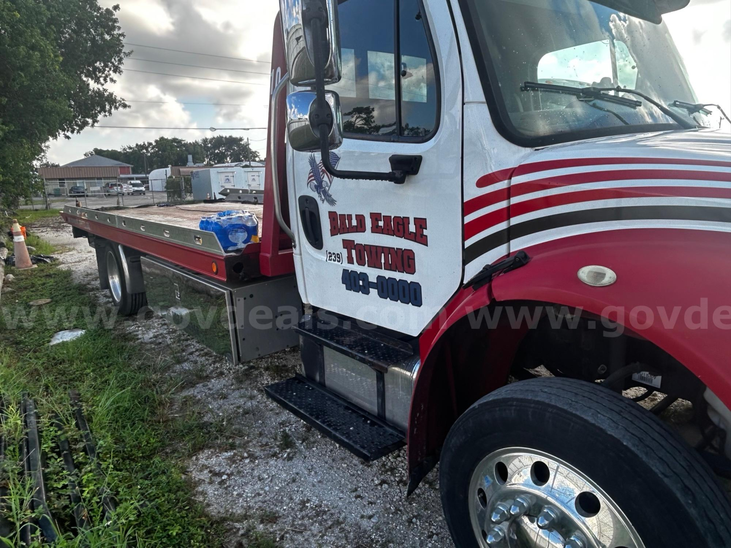 2018 Freightliner M2 tow truck with flatbed showing driver door with Billing Eagle Towing logo and side step.