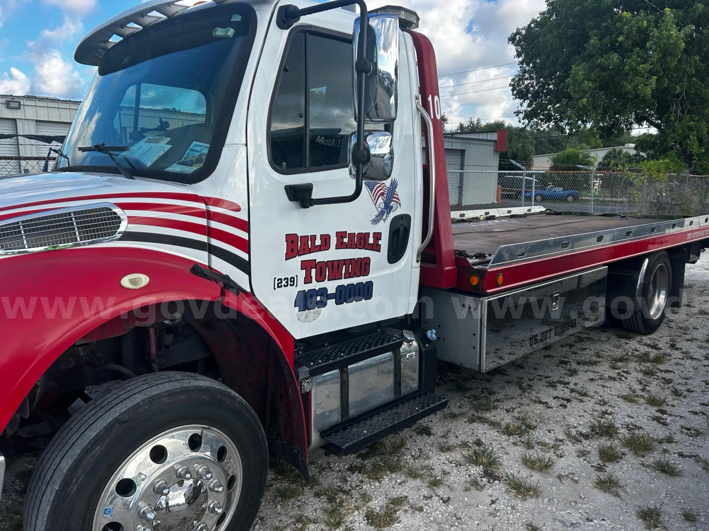 Freightliner M2 tow truck side view showing cab with Bald Eagle Towing logo and flatbed.