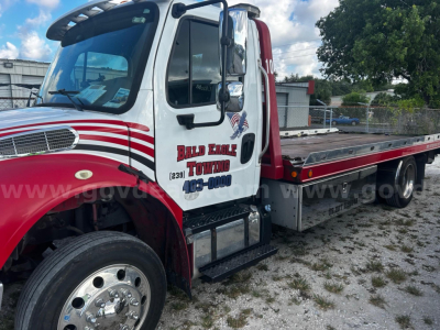 Freightliner M2 tow truck side view showing cab with Bald Eagle Towing logo and flatbed.