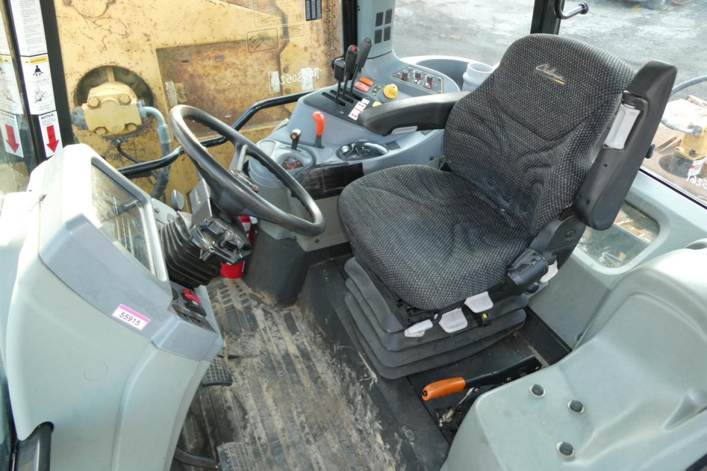 Cab interior of Challenger MT455B showing operator seat, steering wheel, and control console.