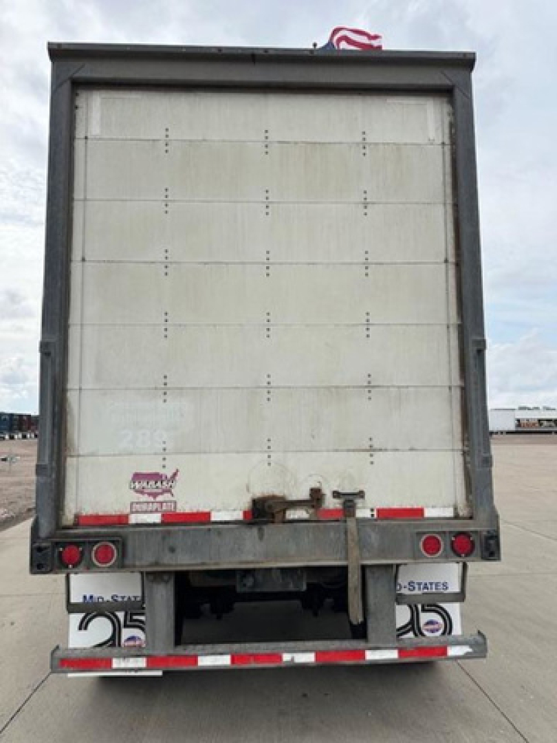 Rear view of a 2016 Wabash van trailer showing the back doors, bumper, and taillights.