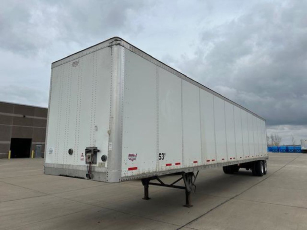 Trailer side showing a 53' Wabash van trailer with front and rear underride guards and landing gear extended.
