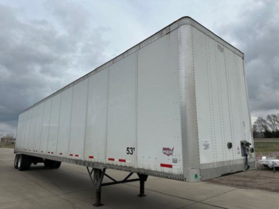 2016 Wabash semi-trailer box showing side height markings and rear doors, with support legs extended and trailer frame visible.