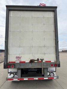 Rear view of a 2016 Wabash van trailer showing the back doors, bumper, and taillights.