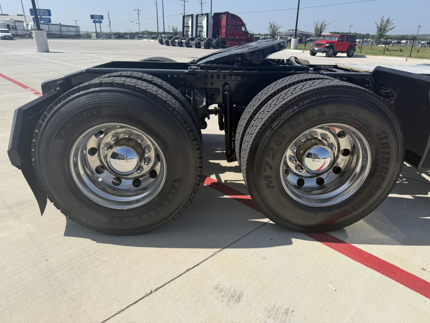 Dual rear axles on a 2020 Mack PI64T tractor showing chrome wheels and dual tires.
