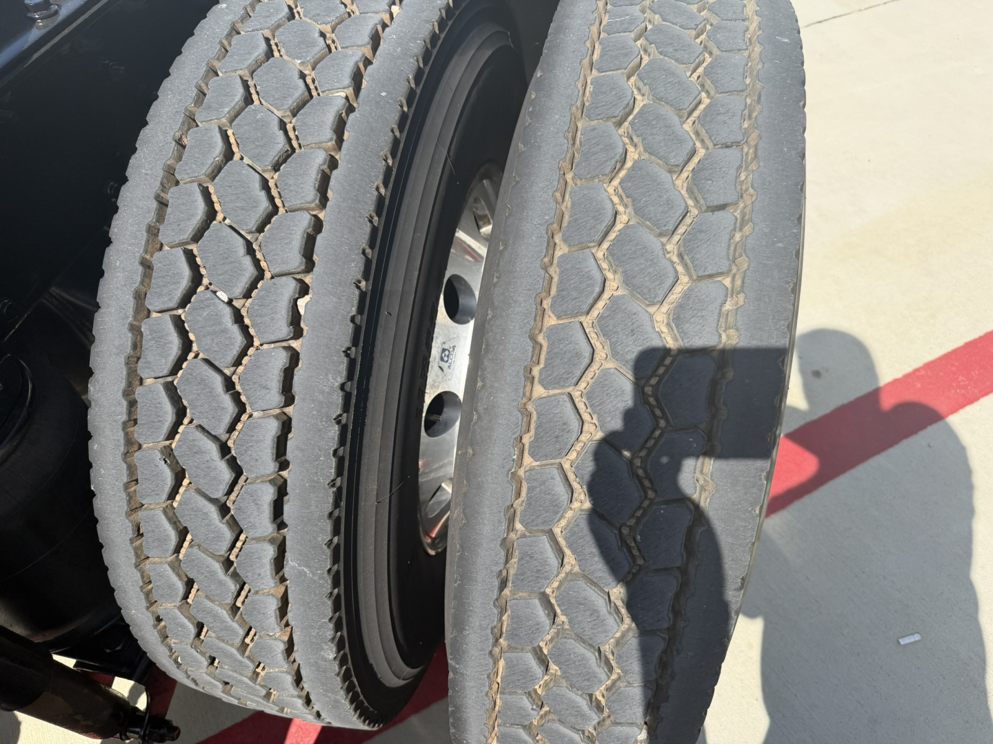 Mack PI64T truck dual rear wheels with tread detail and wheel hub visible.