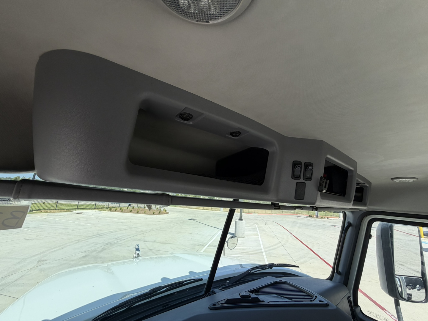Cab interior overhead console of a 2020 Mack PI64T with control panels and vents visible