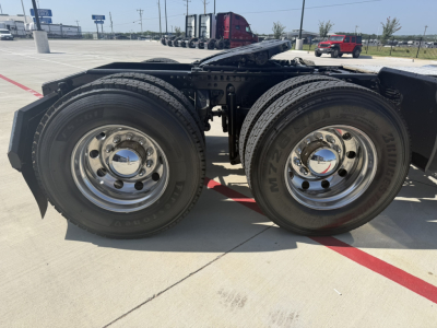 Dual rear axles on a 2020 Mack PI64T tractor showing chrome wheels and dual tires.