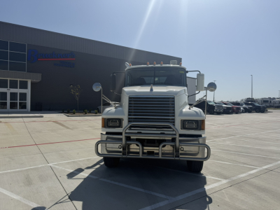 Front view of a white 2020 Mack PI64T conventional daycab truck in a dealership lot showing grille guard and bumper.