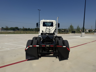 Back view of a white 2020 Mack PI64T conventional daycab truck showing rear chassis and suspension.