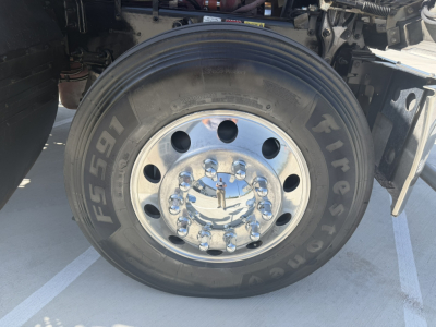 Wheel and tire close-up on a 2020 Mack PI64T truck showing front hub and lug nuts with polished chrome hubcap.
