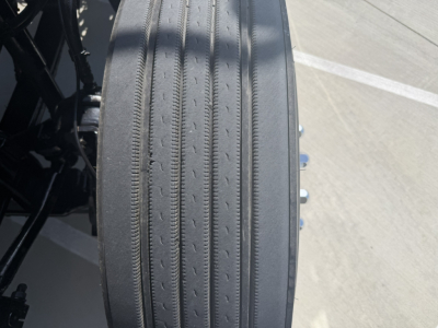 Rear view of a 2020 Mack PI64T truck wheel showing ribbed tire tread and part of the axle/underbody components.