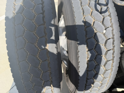 Twin tires of a Mack PI64T truck showing tread pattern and wheel assembly.