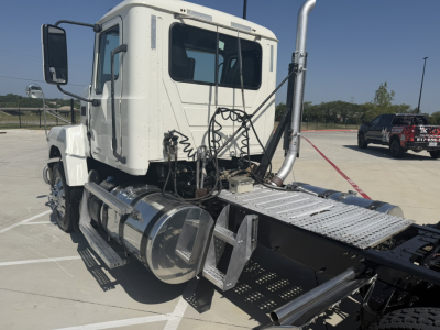Truck cab of a 2020 Mack PI64T in-service with exposed engine bay area, steps, fuel tanks, and chassis visible.