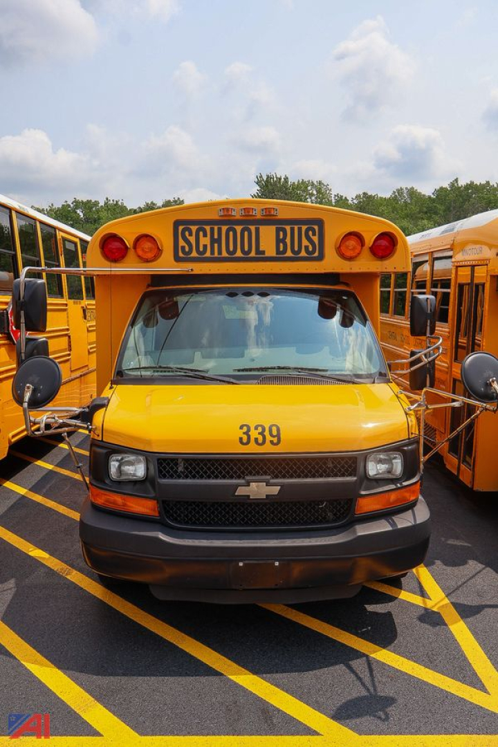 Front view of a yellow 2016 Chevrolet Thomas express mid-size school bus with number 339 and a blank CHEVROLET emblem on grille, 'SCHOOL BUS' sign above windshield.