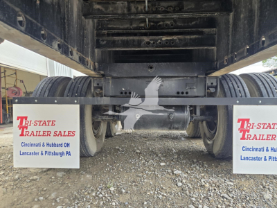Trailer underside showing dual axles with mud flaps reading TRI-STATE TRAILER SALES Cincinnati & Hubbad OH Lancaster & Pittsburgh PA.