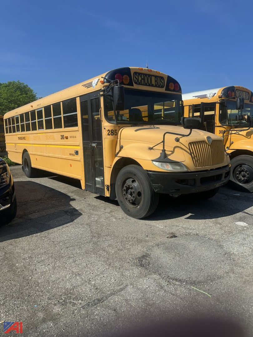 School bus in a parking lot showing CE Series IC Corporation bus with yellow exterior and 'SCHOOL BUS' sign, number 285 on the side, front grille, passenger windows.