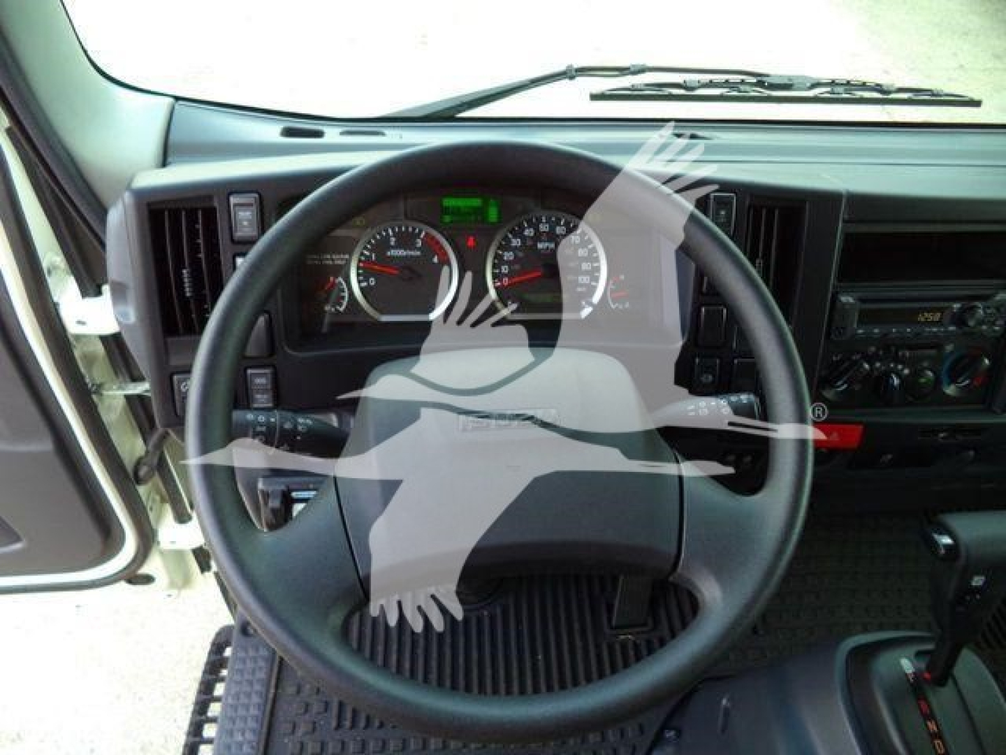Isuzu NPR dashboard and steering wheel view from driver seat.