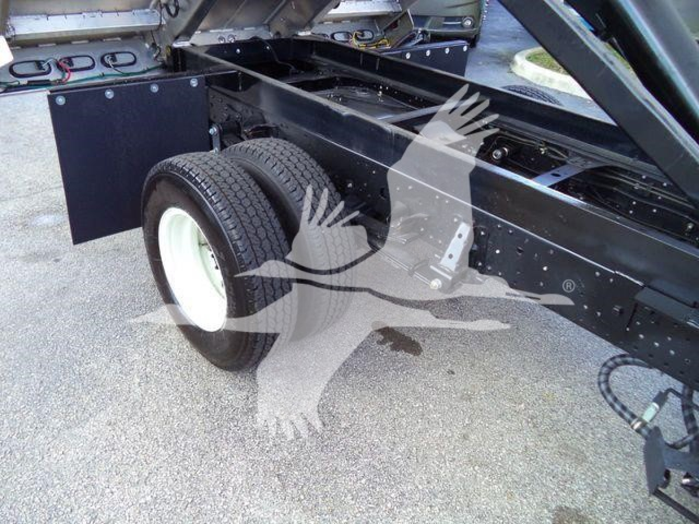 Isuzu NPR-HD truck chassis showing rear dual wheels and frame with components; visible text is not legible.