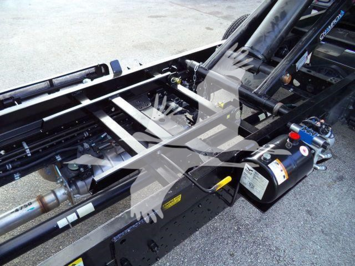 Isuzu NPR HD dump truck chassis showing hydraulic hoses and control valves with labels andManuals