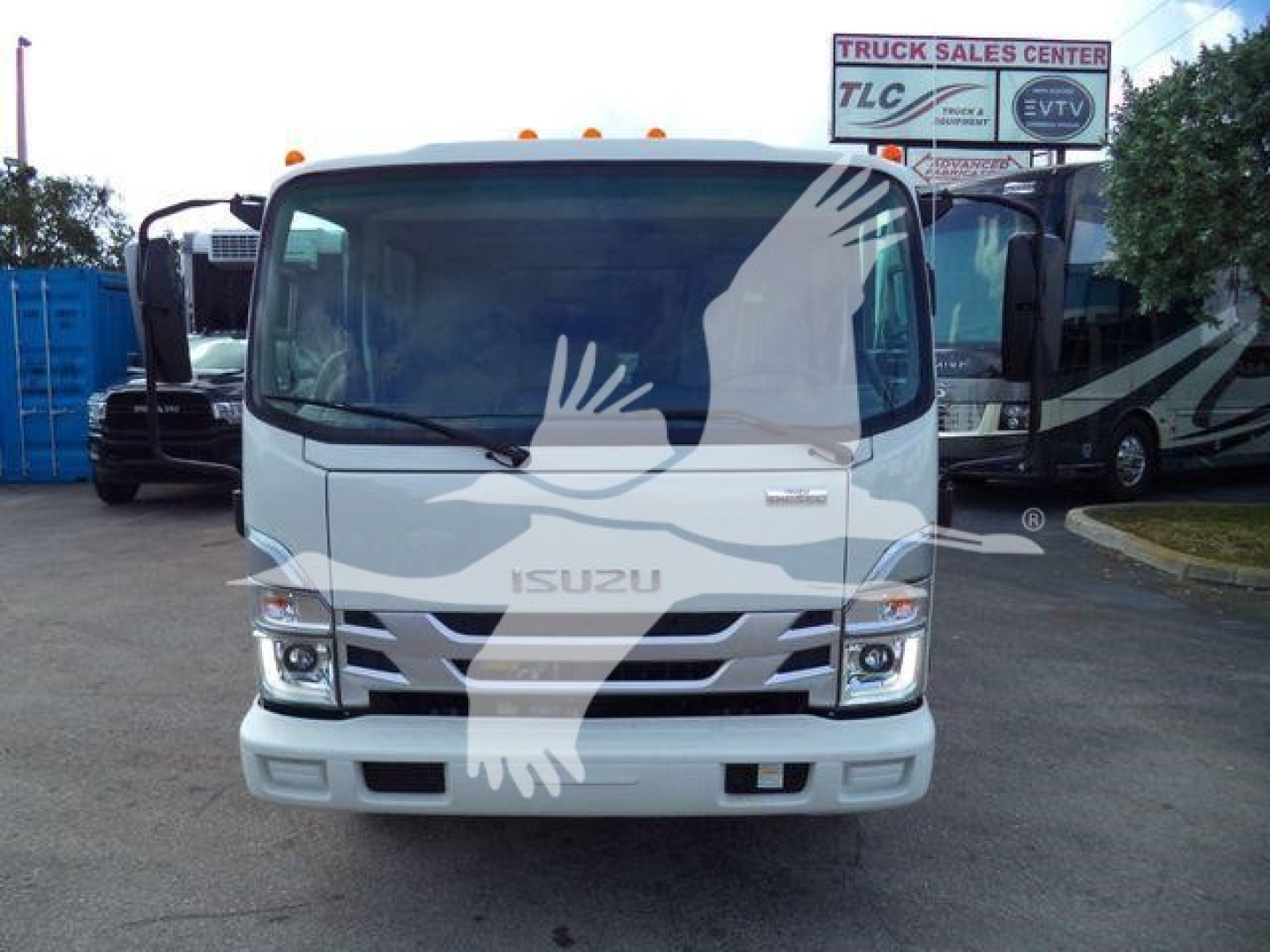 Isuzu NPR HD dump truck front view showing blank grille and windshield, Stock NPRCREWDUMP2 shown in dealership lot.