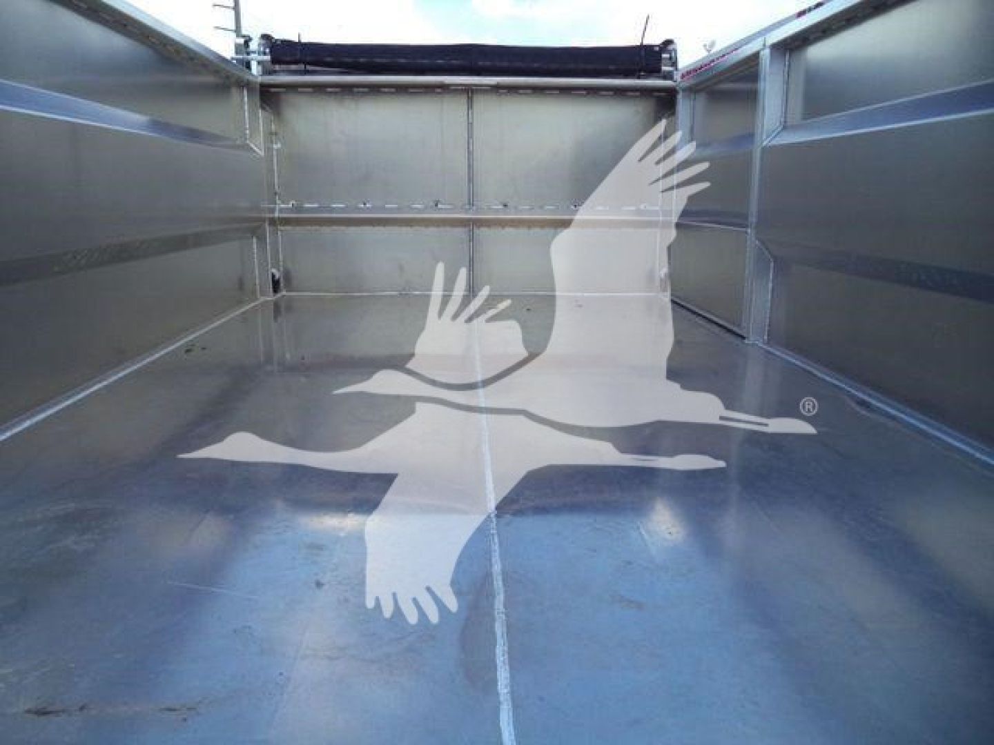 Isuzu NPR-HD dump truck bed interior view showing metallic cargo bed walls and floor