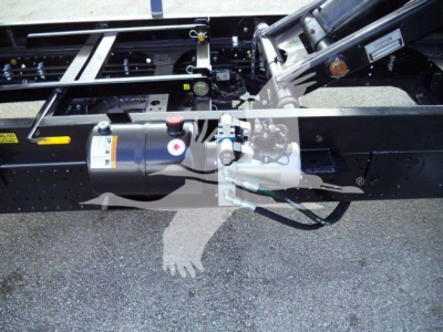 Isuzu NPR HD chassis showing air tank and hydraulic components under truck frame.