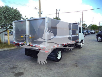 Isuzu NPR HD dump truck in service configuration with aluminum dump body and rear tailgate doors.