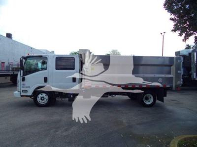 Isuzu NPR-HD dump truck side view with white cab and gray dump body, stock number NPRCREWDUMP2, in a dealership lot.