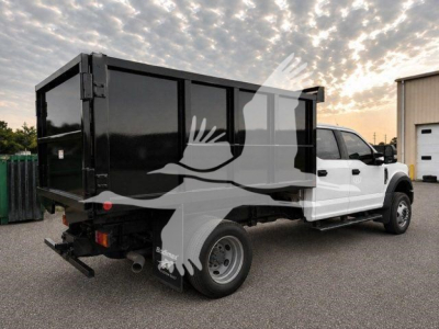 Truck bed with black dump insert and white cab, Ford F-450 XL, rear view showing tail lights and hitch.
