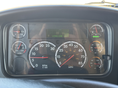 Dashboard of a 2022 Freightliner M2-106 showing analog gauges and digital display.