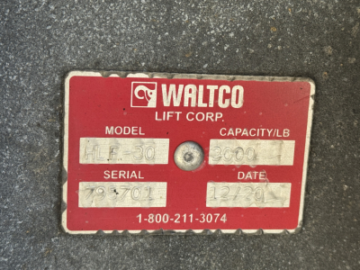 Waltco Lift Corp. identification plate on a Freightliner M2-106 lift brand label showing model HEO30? capacity 2000 lbs, serial 979701, date 12/30, phone 1-800-211-3074.