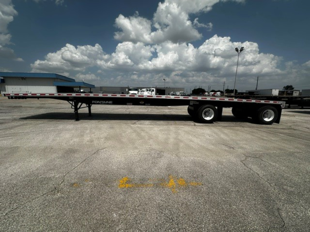 Fontaine 48' combo flatbed trailer side view showing dual rear axles and flat deck with guard rails.