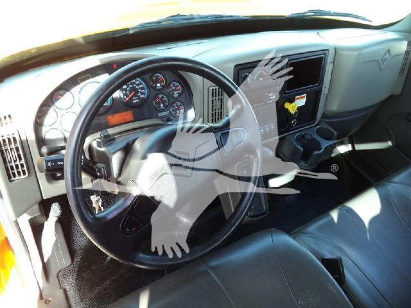 Dashboard and steering wheel of a 2019 International Durastar 4300 truck cab interior with gauges and center console. Visible text includes gauges, warnings, and a digital display.
