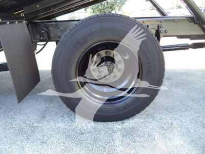 Wheel and suspension area of a 2019 International Durastar 4300 rollback truck showing a single rear wheel with tire and wheel assembly.