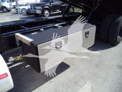 Storage toolbox mounted on side of International Durastar 4300 rollback truck showing dual compartments and mounting hardware.
