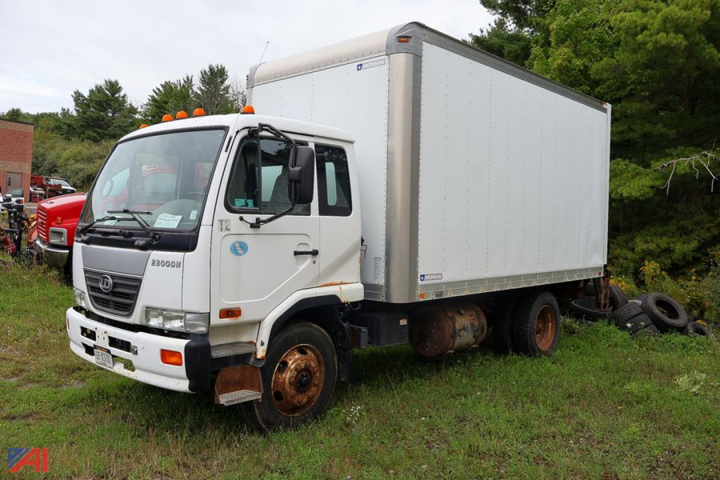 Truck with box body showing Nissan UD2300 chassis and cargo box.