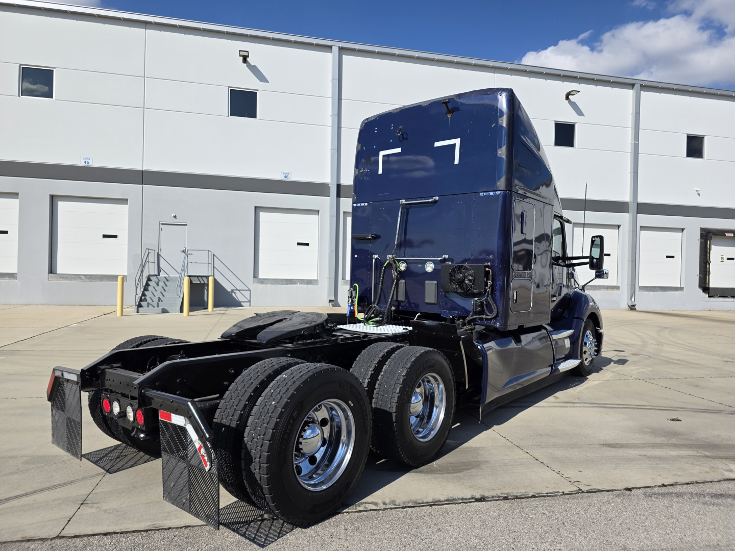 Kenworth T680 tractor rear and side view showing dual rear axles and sleeper cab.