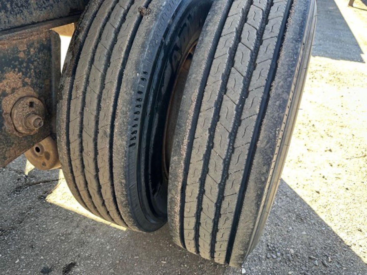 Trailer rear dual tires showing tread and suspension mount attached