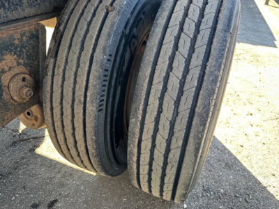 Trailer rear dual tires showing tread and suspension mount attached