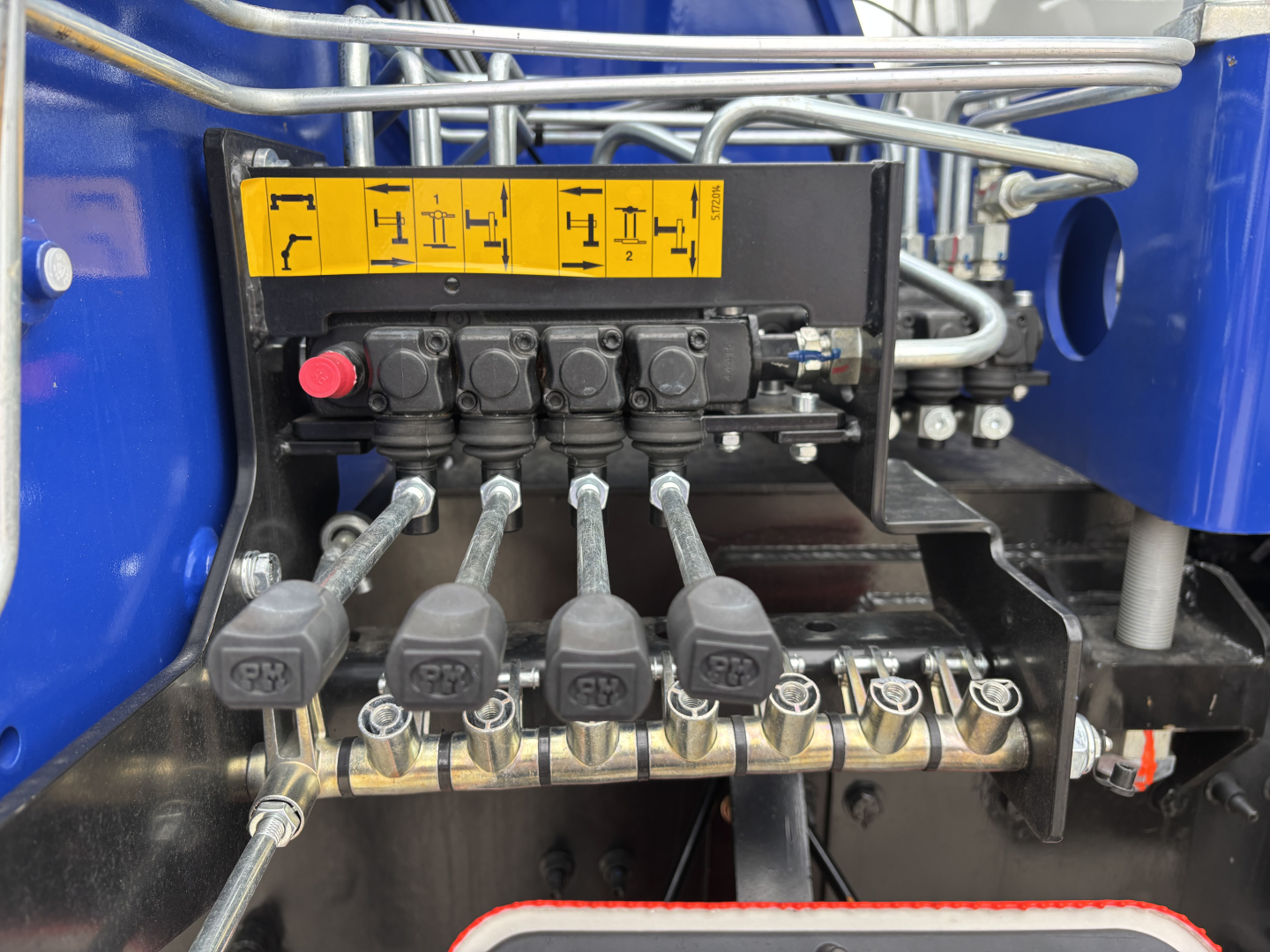 Mack GR64F crane controls and hydraulic valve bank with levers and yellow diagram label.