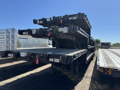 Great Dane steel spread air drop deck trailer in in-service condition with extended deck and elevated ride heights.
