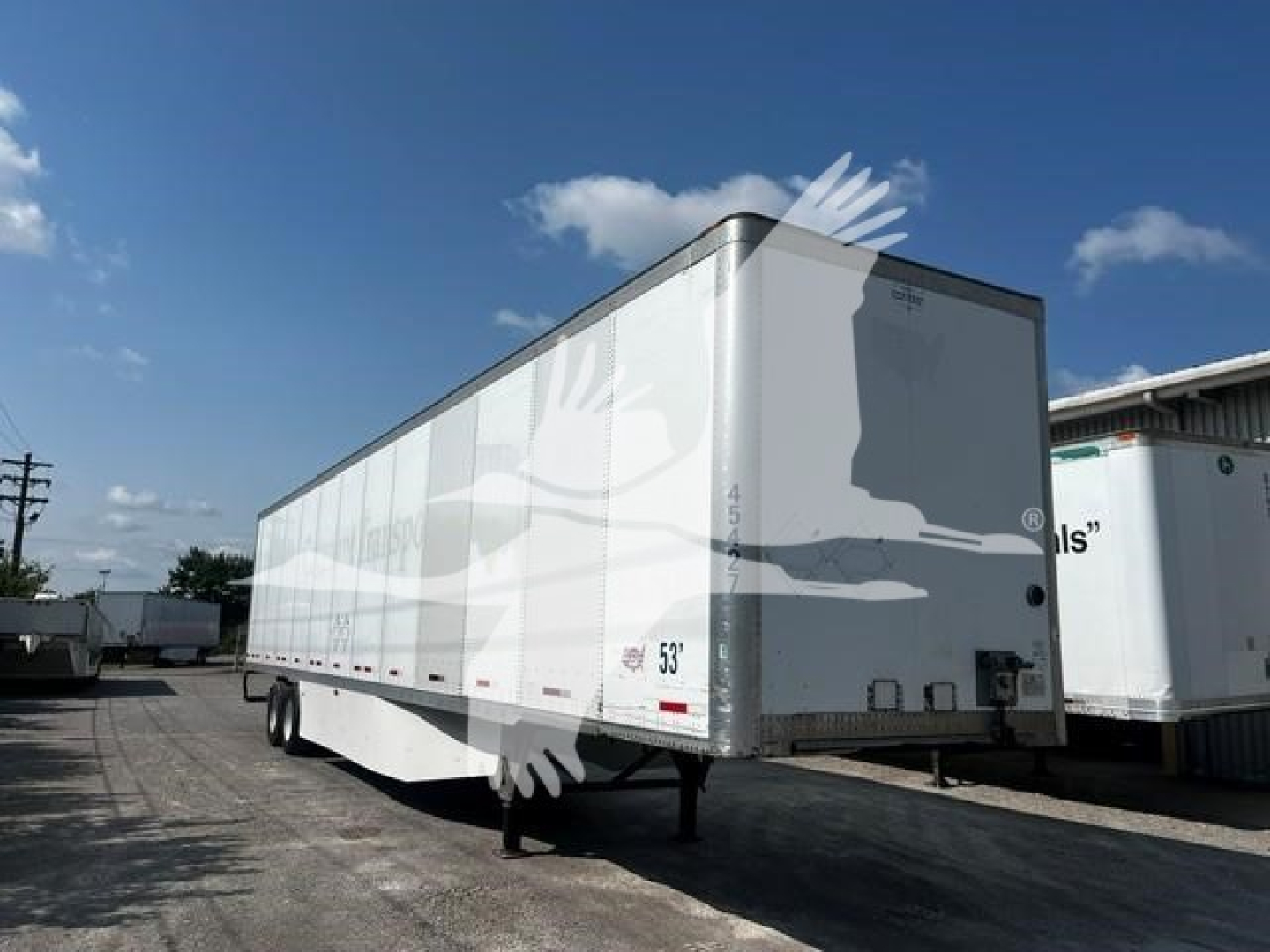Trailer showing a white Wabash DVCVHPC box trailer with dual rear doors and a 53' length in a dealership lot.