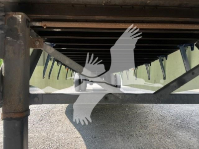Trailer underside view showing suspension and frame with landing gear and support beams.