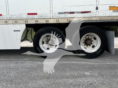 Trailer wheels and lower side of a 2017 Wabash DVCVHPC trailer showing dual rear axles with steel wheels and tires.
