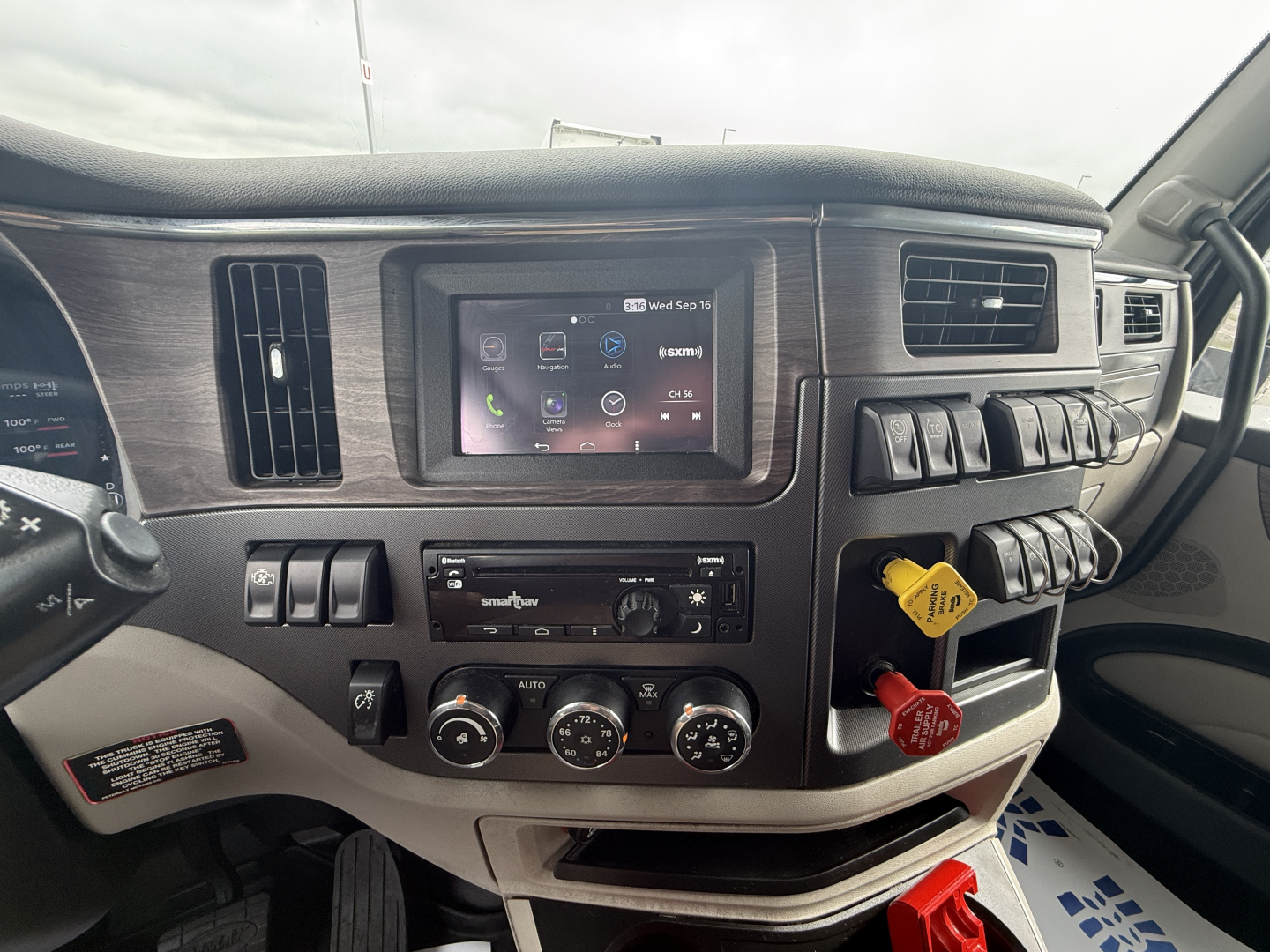 Peterbilt 579 truck interior dashboard view with touchscreen display and controls.
